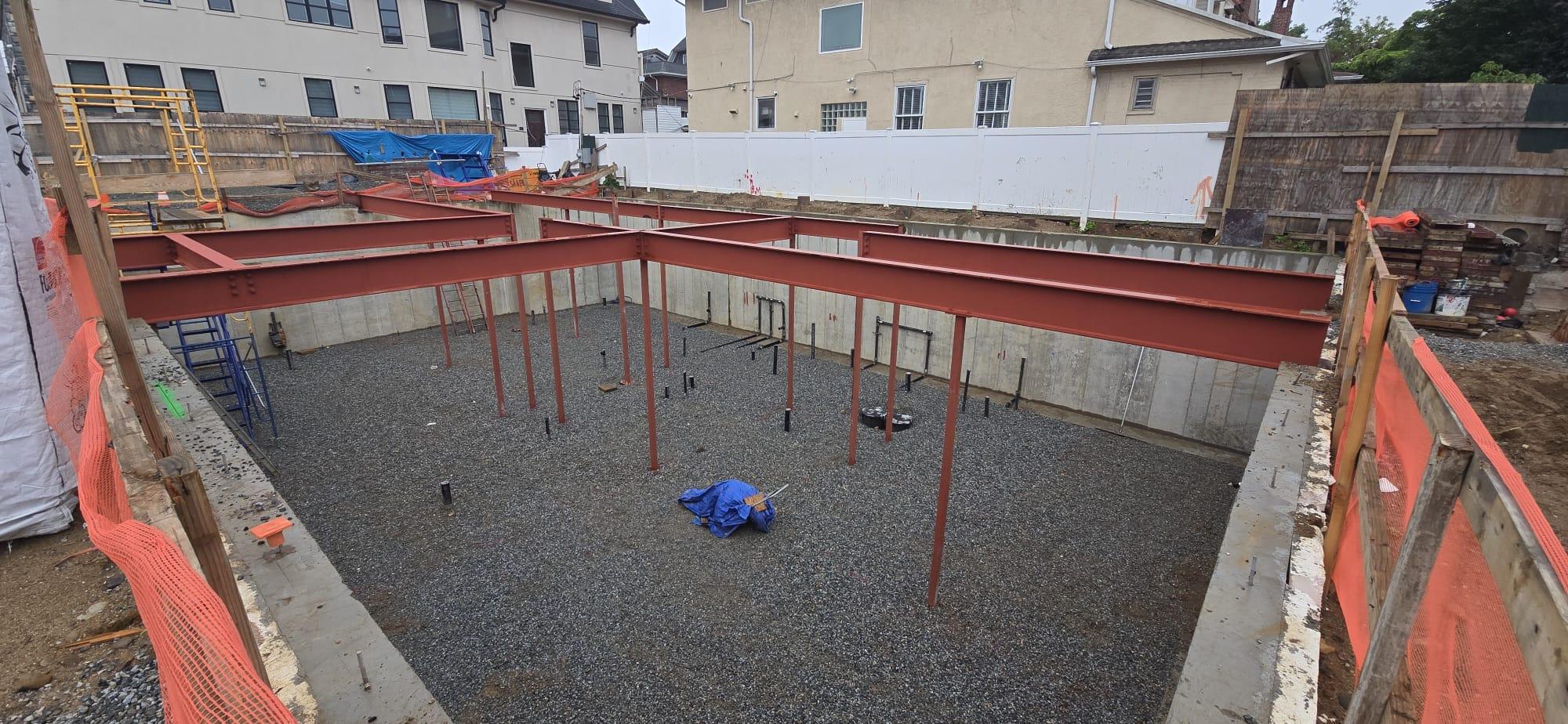 Red primed steel beams in foundation